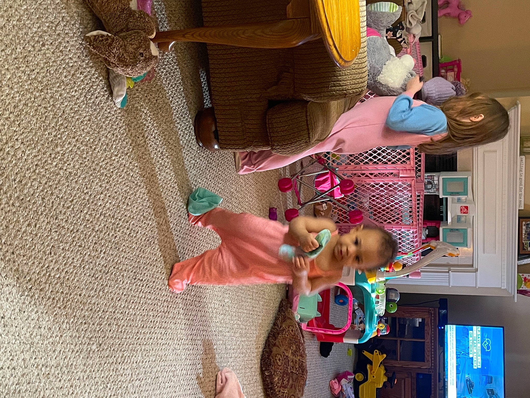 Wynter is registered to the contest to win money with this photo: art, baby_toys, bookcase, child, collection, flooring, fun, hat, machine, pattern, person, pink, play, room, shelf, shelving, textile, toddler, toy, visual_arts