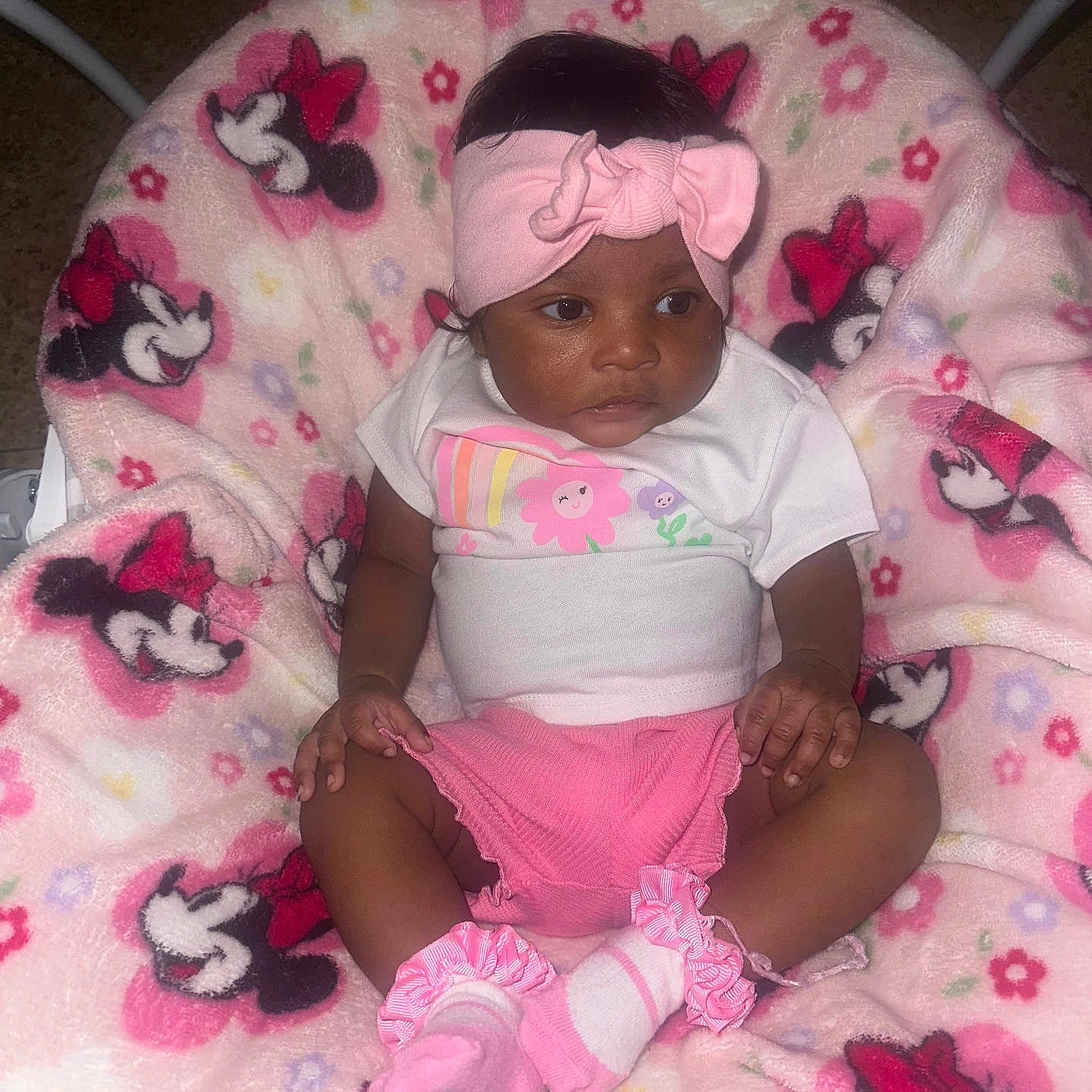 Cedrionna is registered to the contest to win money with this photo: baby, blanket, casual_clothing, child, comfort, cute, fabric, headband, indoors, infant, minnie_mouse, pattern, pink_clothing, portrait, seated, small_hands, socks, soft_texture, toddler, young_child