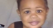 Josiah joined the competition — help win amazing prizes! child, toddler, portrait, face, eyes, curious, indoors, car_seat, safety_harness, strap, black_clothing, sitting, close_up, headshot, home, background, blurred, soft_lighting, photography, person