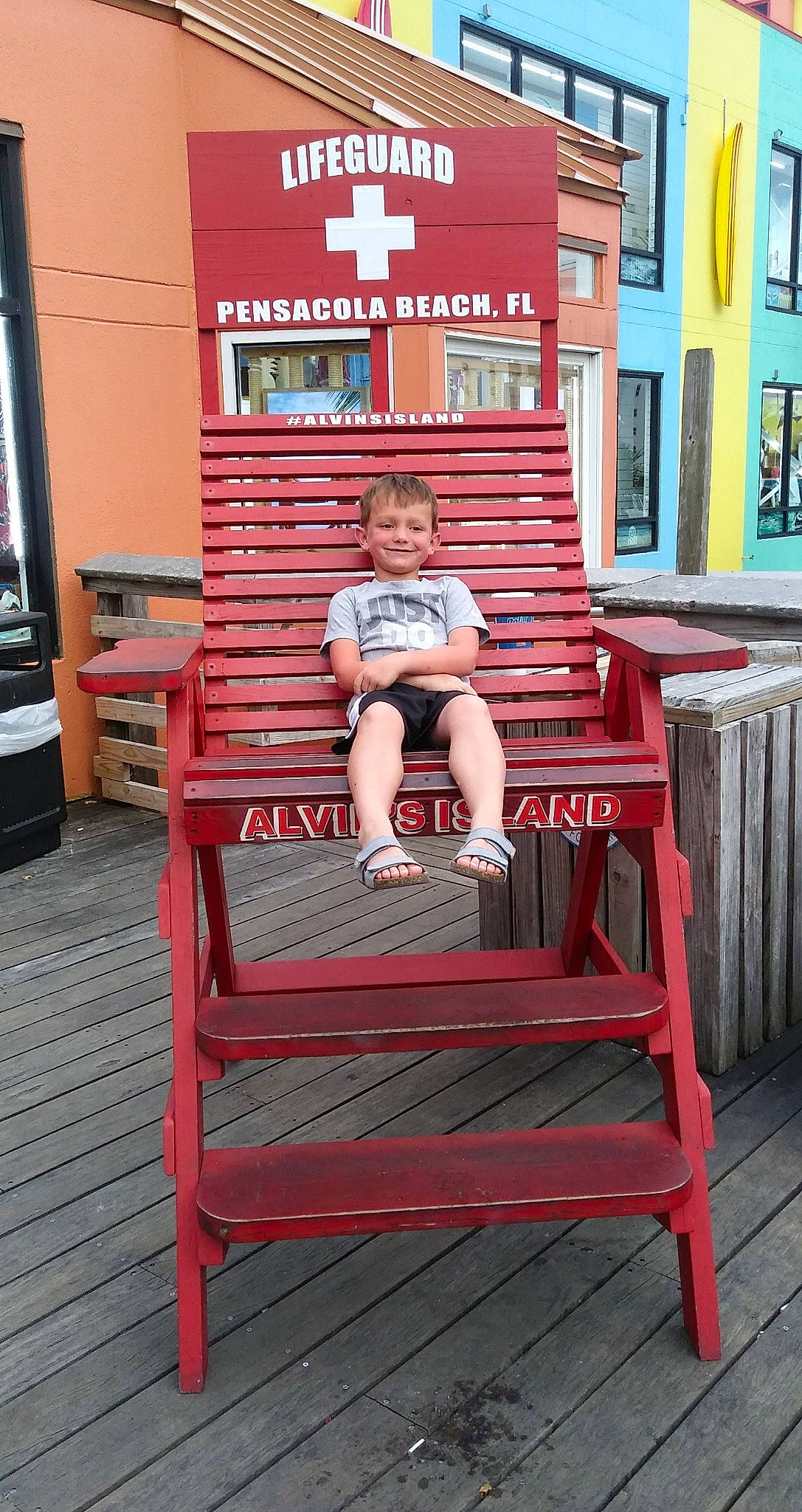 Kelly is registered to the contest to win money with this photo: child, comfort, foot, fun, hardwood, human_body, human_leg, joy, leg, leisure, magenta, outdoor_furniture, person, red, room, shorts, sitting, t_shirt, thigh, vacation