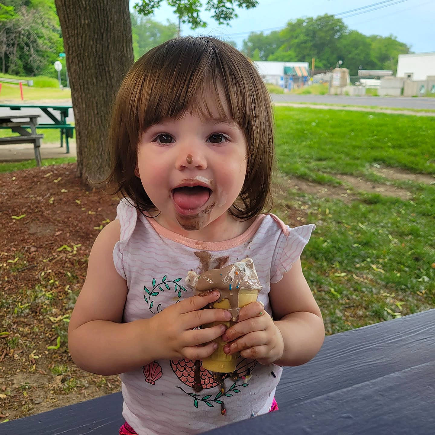 Vivian joined the competition — help win amazing prizes! baby, bangs, blond, child, food, fun, gesture, grass, grass_family, happy, leaf, leisure, people_in_nature, person, plant, recreation, sleeveless_shirt, summer, thumb, toddler