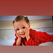 Ylonna a rejoint le concours — aidez-le/la à gagner de superbes lots ! child, smiling, red_clothing, sequin, portrait, happy, face, hands, cute, lying_down, indoors, young_child, hair_tied, joyful, expression, playful, person, closeup, bright, fashion