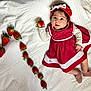 baby, child, colorful, cute, food, footwear, fresh, fruit, hand, happy, headband, infant, lying_down, polka_dot, portrait, red_dress, small_shoes, soft_lighting, strawberry, white_sheet