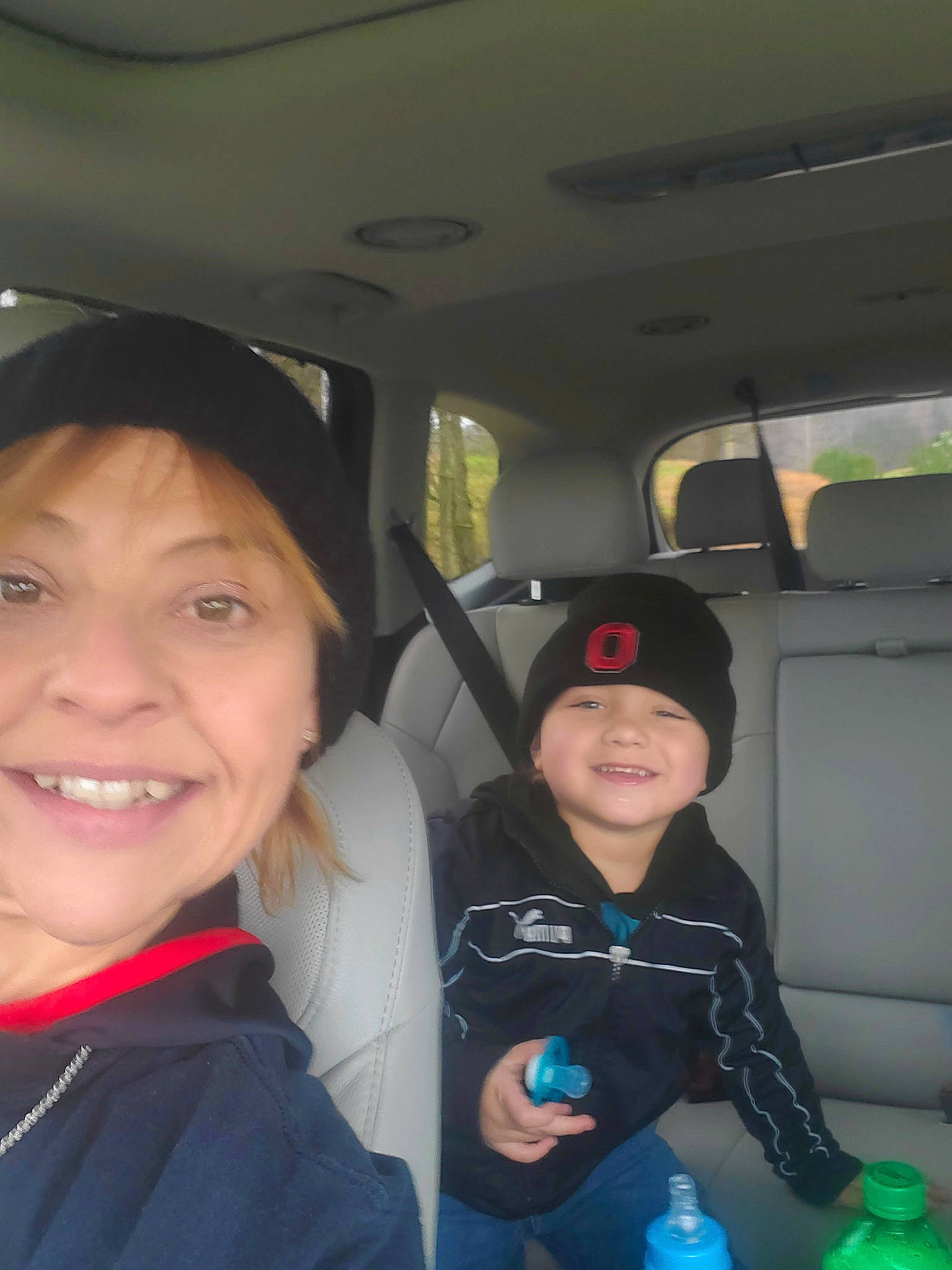 Bear is registered to the contest to win money with this photo: auto_part, automotive_design, automotive_exterior, car, car_seat, electric_blue, face, family_car, fun, happy, headwear, jacket, joy, motor_vehicle, person, plastic_bottle, seat_belt, skin, smile, toddler