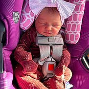Josephine joined the competition — help win amazing prizes! newborn, baby, sleeping, car_seat, purple, headband, bow, onesie, infant, safety_harness, cute, child, closed_eyes, soft_lighting, indoor, small_person, wrapped, peaceful, clothing, resting