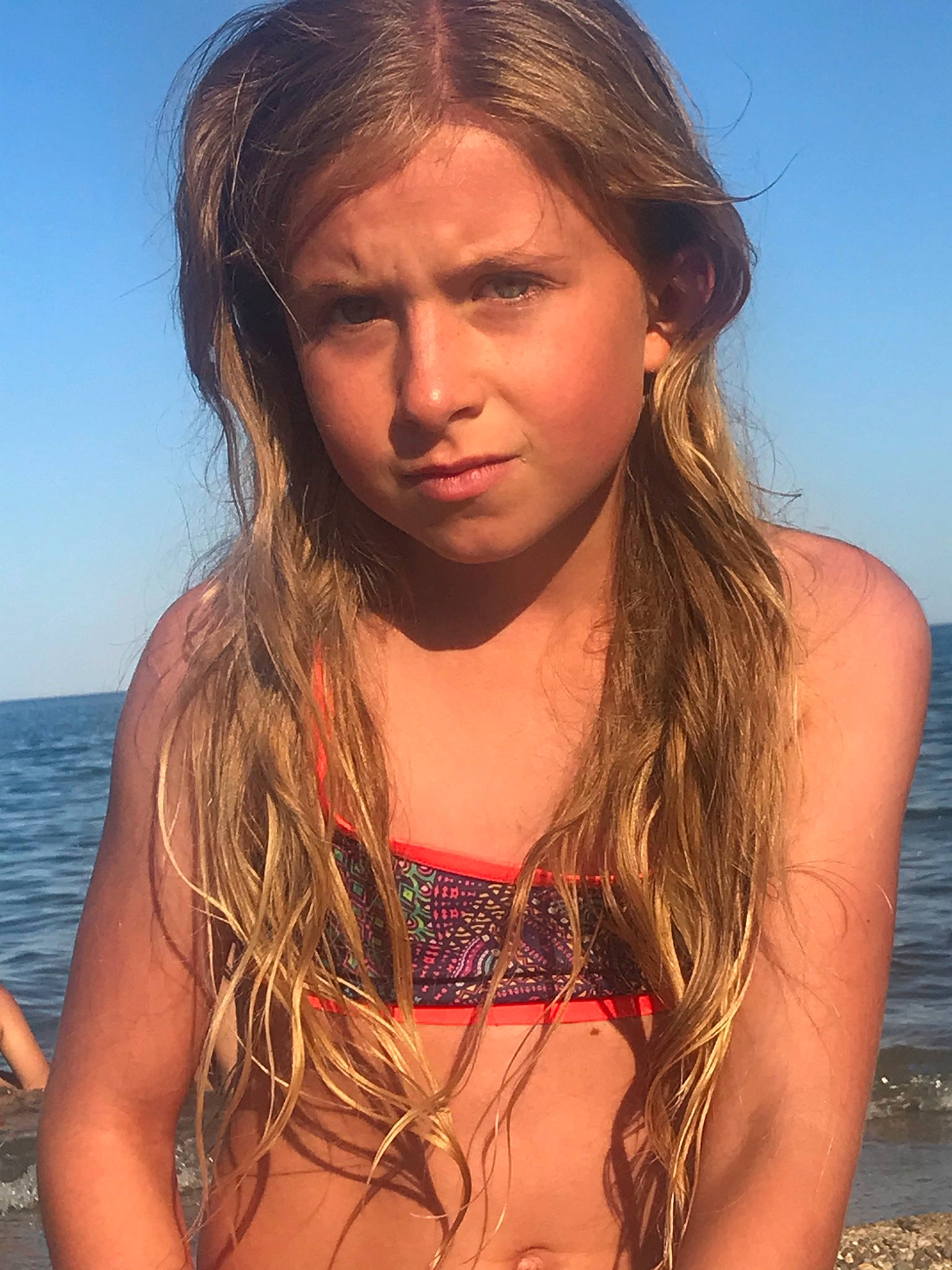 Lorna participe au concours pour gagner de l'argent avec cette photo : black_hair, eye, flash_photography, hair, happy, head, layered_hair, lingerie_top, lip, long_hair, muscle, neck, people_in_nature, people_on_beach, person, shoulder, sky, surfer_hair, swimsuit_top, swimwear