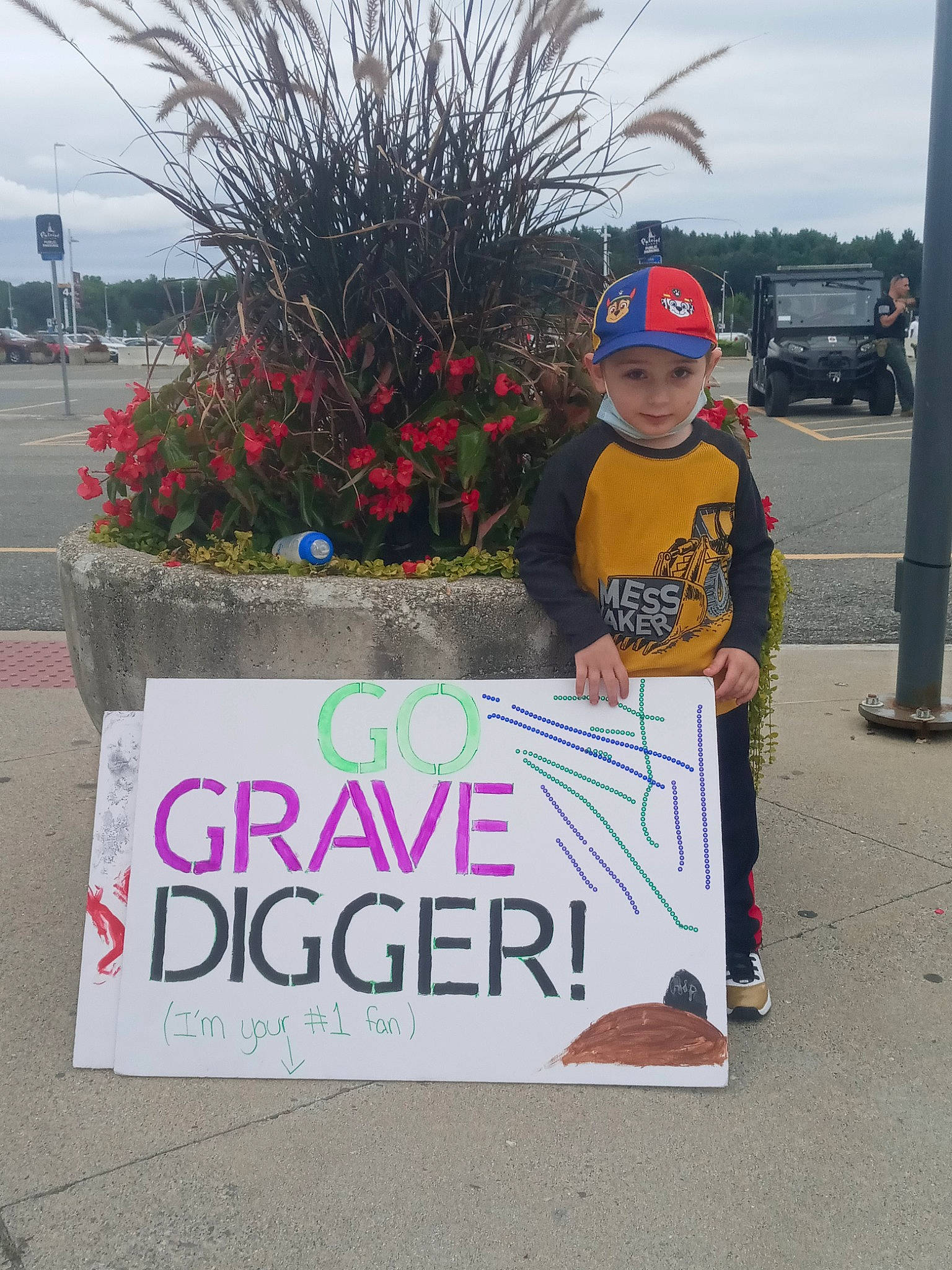 Junior joined the competition — help win amazing prizes! advertising, asphalt, baseball_cap, cap, event, flower, font, grass, hat, headwear, landscape, person, plant, public_event, public_space, recreation, road_surface, shorts, sky, t_shirt