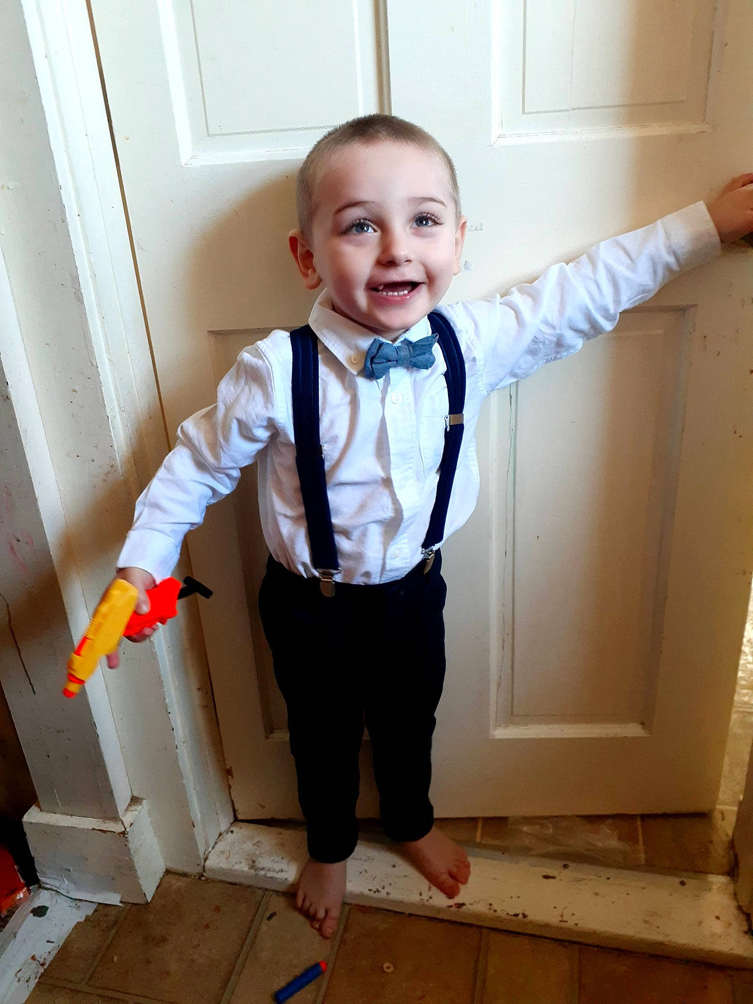 Junior is registered to the contest to win money with this photo: baby_toddler_clothing, blazer, collar, dress_shirt, finger, flooring, formal_wear, gesture, happy, human_body, joint, joy, outerwear, person, shoulder, sleeve, smile, standing, t_shirt, toddler