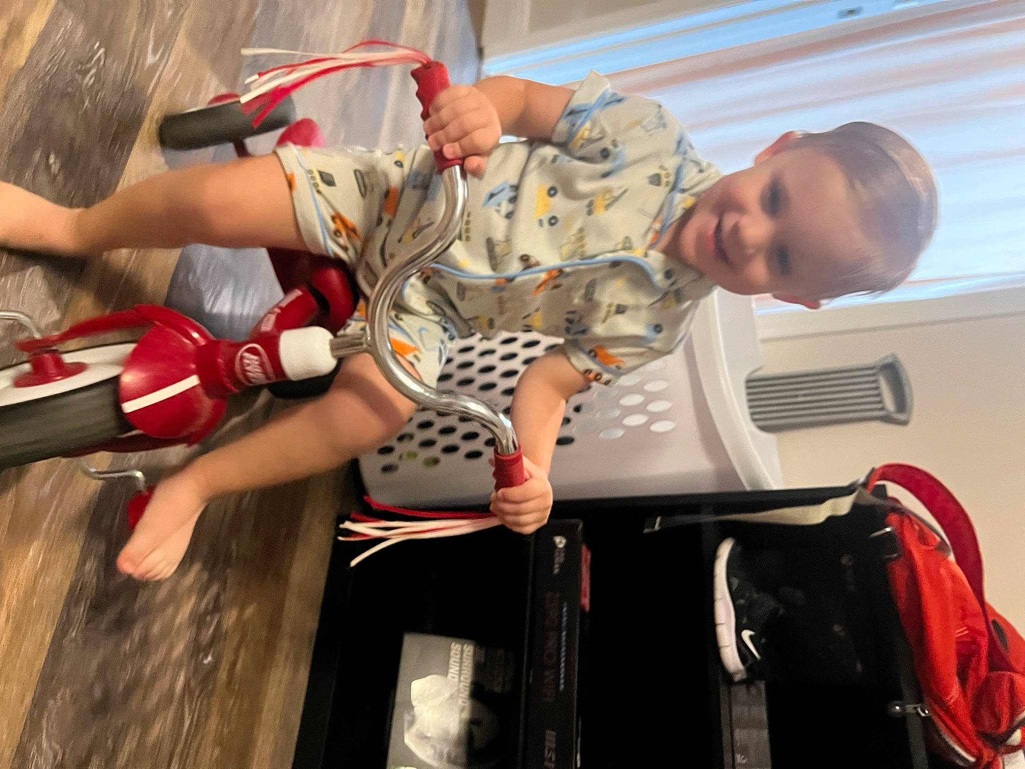 Judson is registered to the contest to win money with this photo: bag, carmine, child, competition, entertainment, event, fictional_character, fun, hat, human_leg, joy, knee, luggage_and_bags, performing_arts, person, room, sandal, shorts, sock, thigh