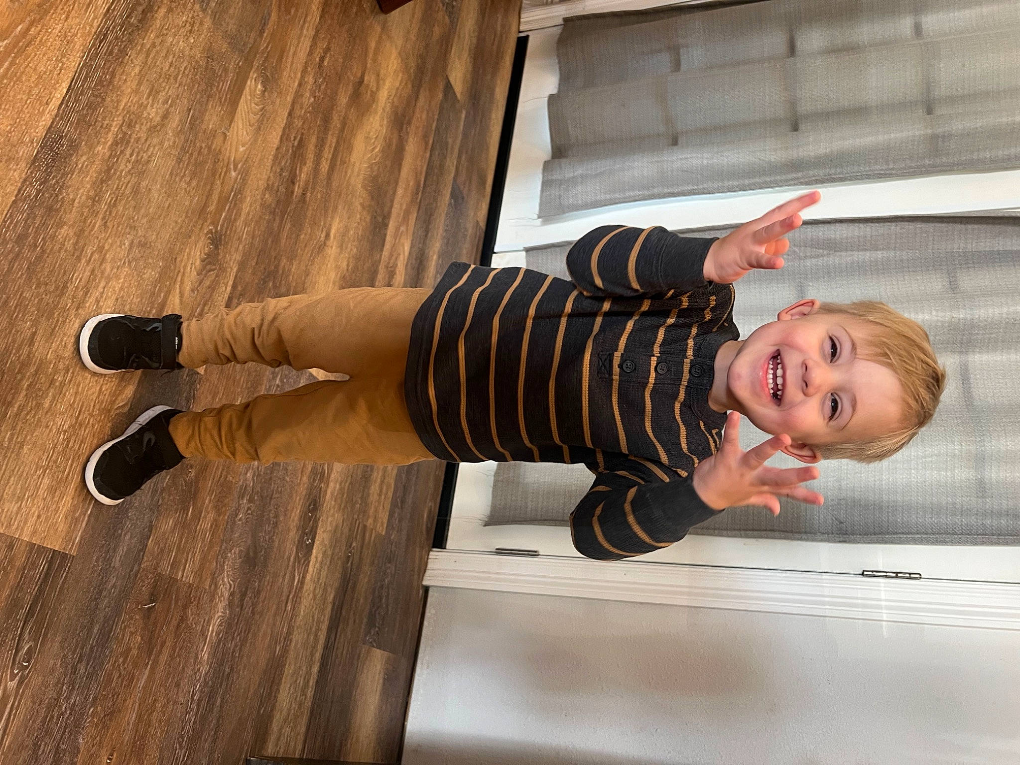 Judson is registered to the contest to win money with this photo: door, flooring, foot, happy, hardwood, human_leg, joy, knee, pattern, person, sleeve, smile, sock, thigh, toddler, varnish, waist, window, wood, wood_flooring
