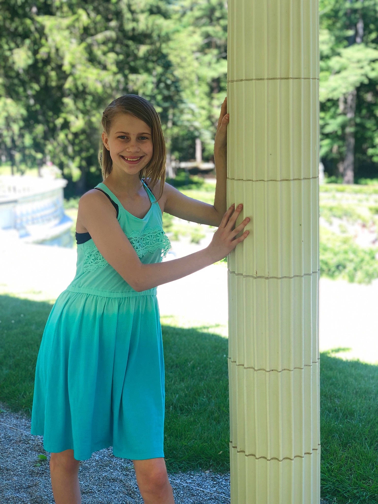 Lexus is registered to the contest to win money with this photo: arm, blond, clothing, dress, grass, green, joy, lady, pattern, person, photography, plant, shoulder, standing, summer, tree, trunk, turquoise, waist, yellow