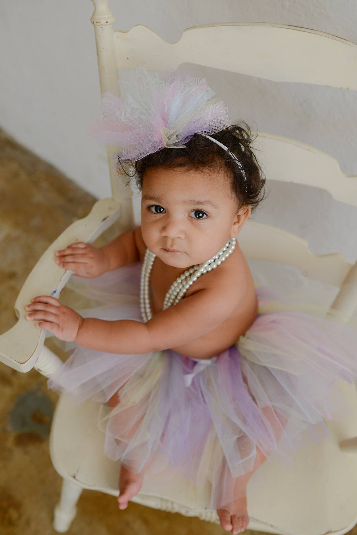 Taytum is registered to the contest to win money with this photo: baby_toddler_clothing, bridal_accessory, day_dress, dress, embellishment, eye, eyelash, face, flash_photography, hair, hair_accessory, happy, head, headband, headpiece, jewellery, person, pink, smile, toddler
