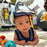 baby, infant, toys, fabric_book, blanket, curious, indoor, playtime, colorful, child, person, cute, soft, headwear, expression, closeup, floor, development, early_learning, play