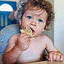 Swan participe au concours pour gagner de l'argent avec cette photo : toddler, child, blue_eyes, curly_hair, snack, waffle, table, hand, face, portrait, indoor, eating, cute, person, skin, expression, young_child, curly, mouth, sitting