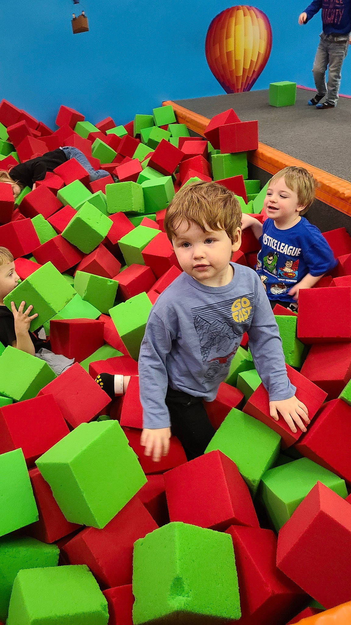 Jonathan is registered to the contest to win money with this photo: event, fun, games, grass, green, happy, inflatable, leisure, nature, people, people_in_nature, person, recreation, red, sharing, shorts, summer, t_shirt, toddler, world