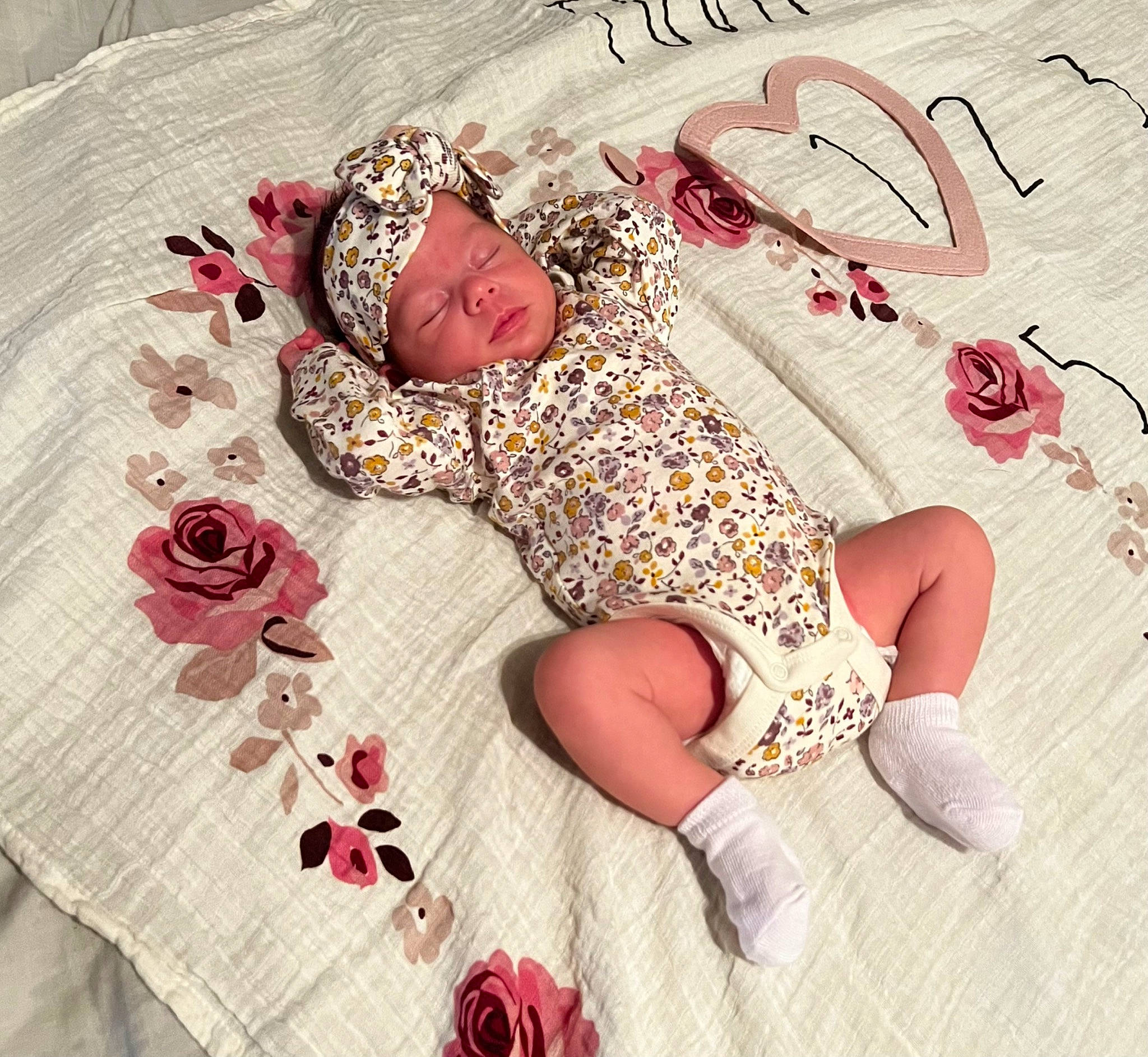 Alena is registered to the contest to win money with this photo: baby_toddler_clothing, carmine, comfort, finger, flooring, flower, font, foot, happy, headwear, human_leg, knee, linens, magenta, pattern, person, petal, pink, plant, sleeve