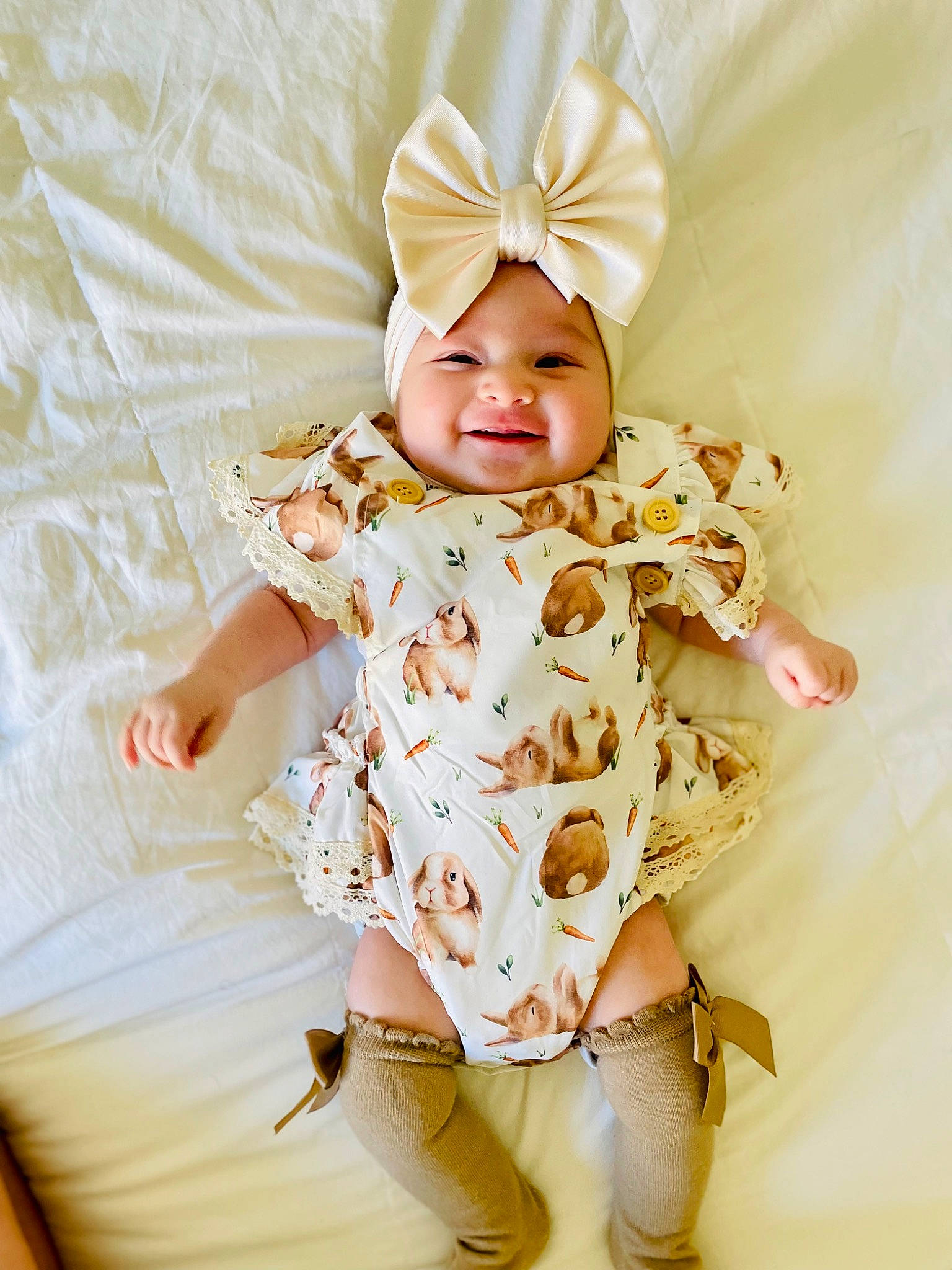 April is registered to the contest to win money with this photo: arm, baby, baby_sleeping, baby_toddler_clothing, brown_hair, comfort, eye, fashion_accessory, hair_accessory, happy, head, headband, headpiece, headwear, joy, linens, magenta, pattern, peach, person