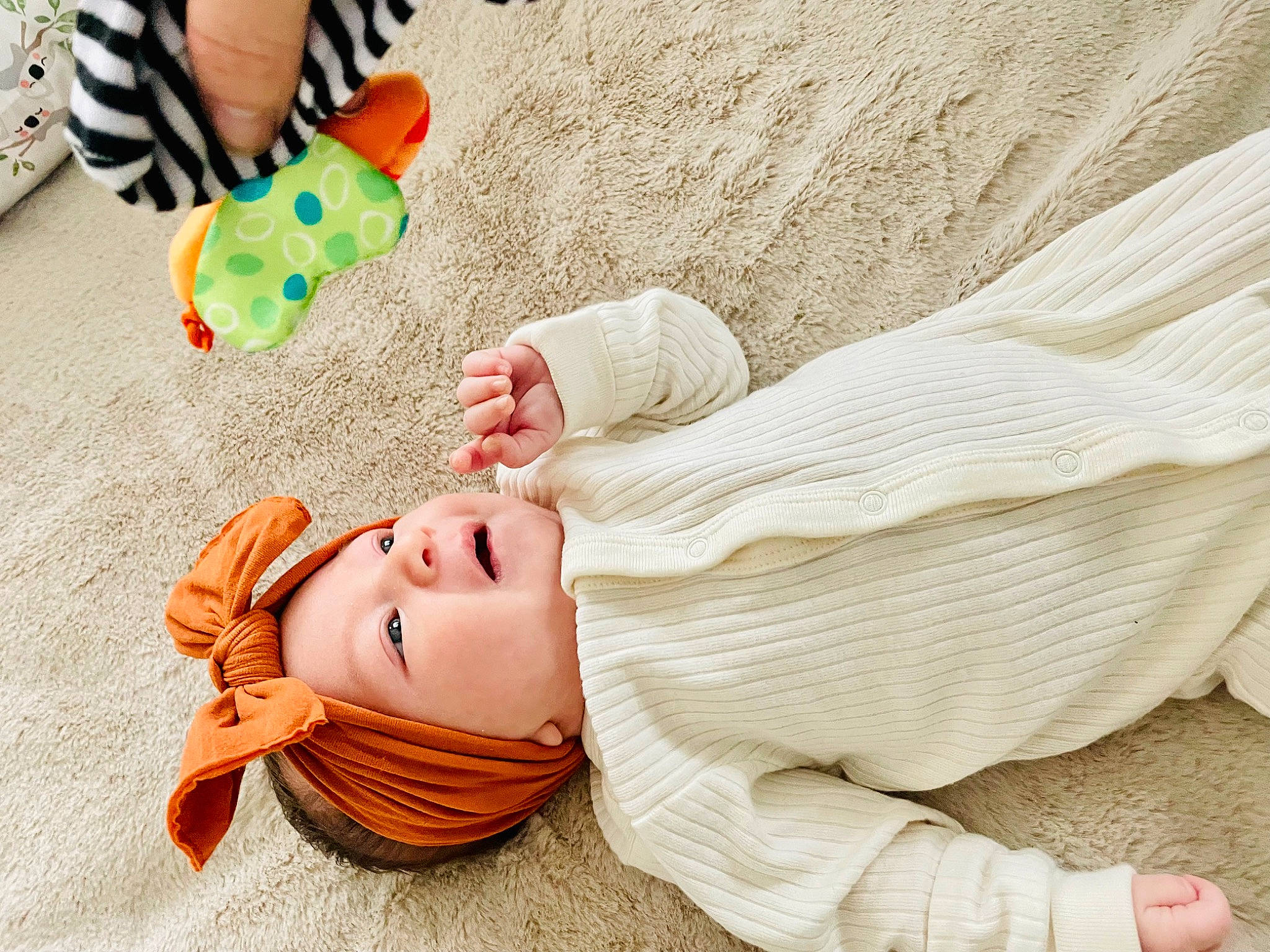 April is registered to the contest to win money with this photo: baby, baby_products, beauty, child, comfort, fashion_accessory, finger, fun, grass, happy, headgear, human_leg, joint, leisure, linens, people, people_in_nature, person, sitting, textile