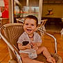 toddler, child, smiling, happy, sitting, chair, indoor, car_key, diaper, casual_clothing, woven_chair, barefoot, cute, portrait, baby, young_child, playful, joyful, person, expression