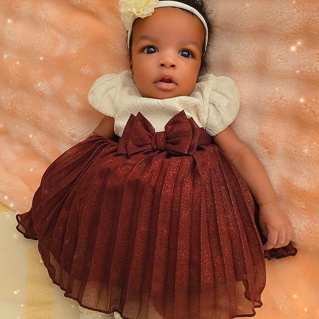 Aliysson Orrico is registered to the contest to win money with this photo: baby, big_eyes, blanket, bow, cute, dress, fashion, gaze, headband, infant, lying_down, maroon, newborn, peach_background, portrait, ruffles, socks, soft_texture, sparkles, studio_style