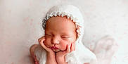 Aurora is registered to the contest to win money with this photo: newborn, baby, sleeping, infant, hands, face, bonnet, white_clothing, soft_texture, cute, peaceful, portrait, closeup, skin, child, wrapped, chubby_cheeks, headwear, studio, adorable