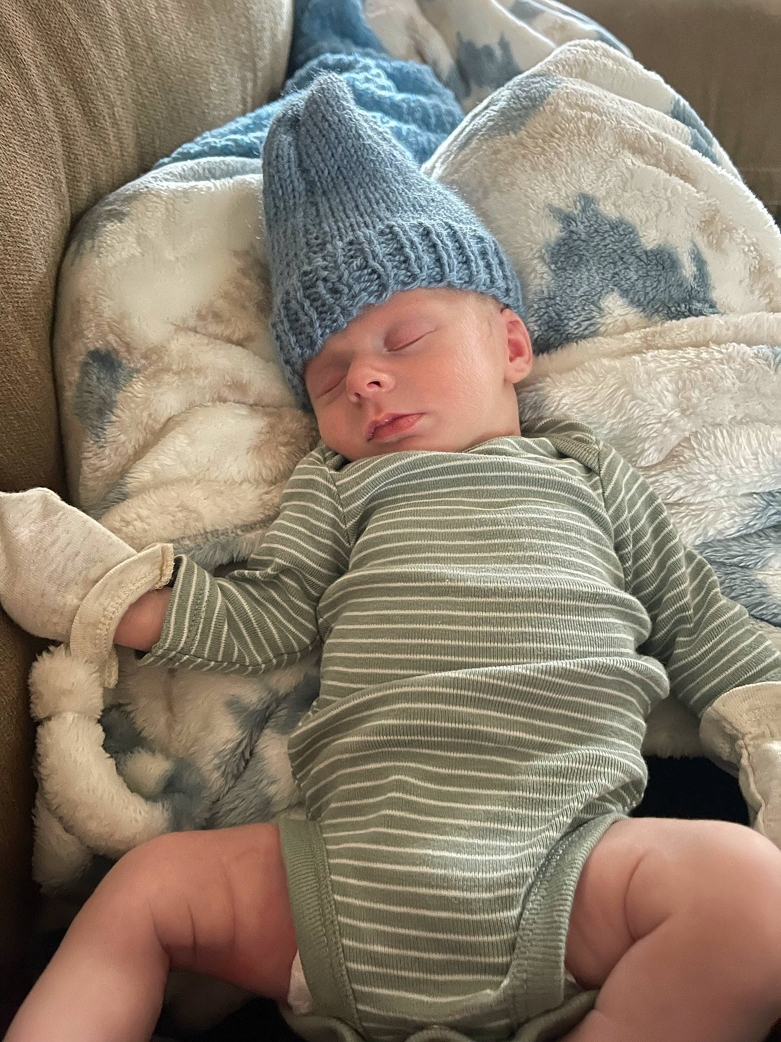 Kolson joined the competition — help win amazing prizes! baby, baby_sleeping, cap, child, comfort, couch, elbow, finger, hand, interaction, lap, leg, mammal, people, person, skin, textile, thigh, toddler, trunk
