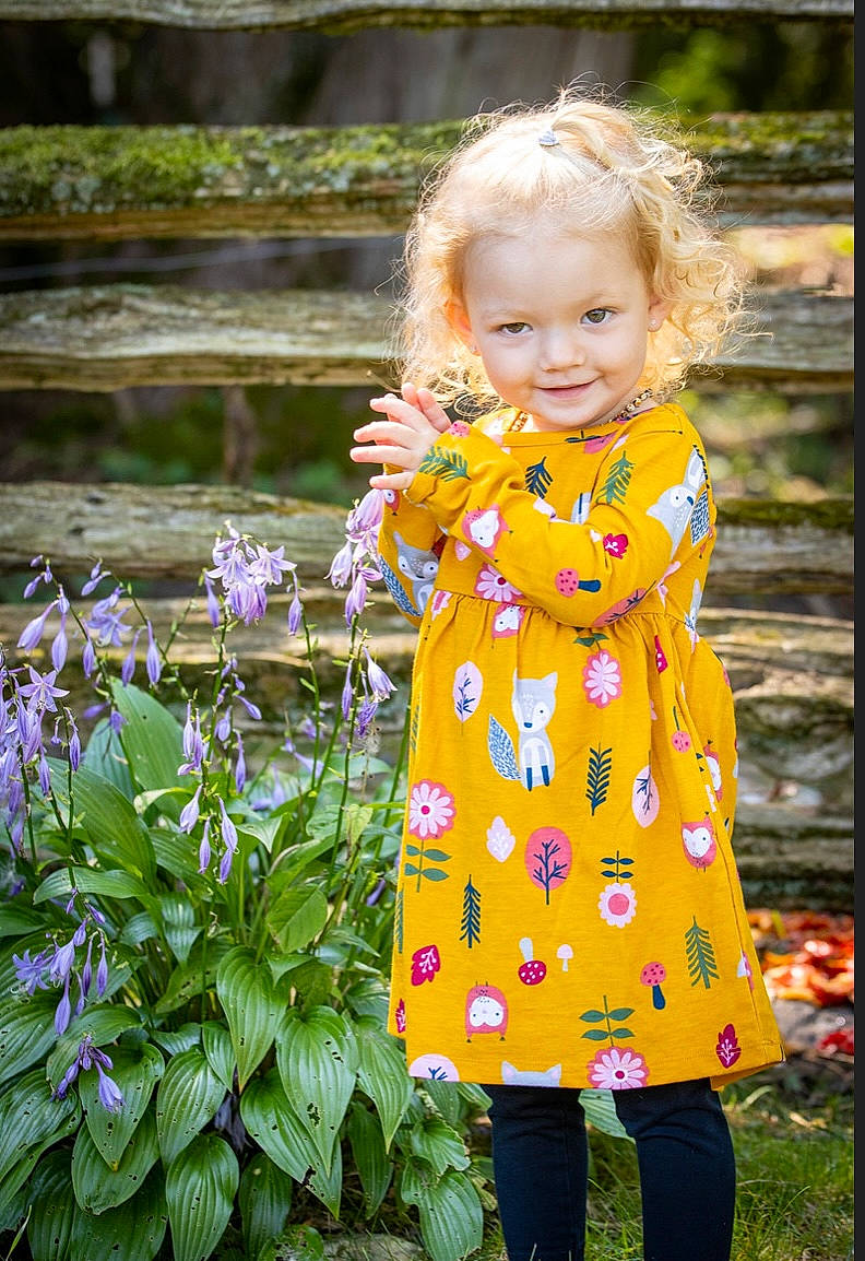 Wyatt is registered to the contest to win money with this photo: botany, child, child_model, clothing, dress, flower, grass, joy, outerwear, pattern, person, plant, sleeve, spring, toddler, wildflower, yellow