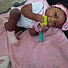 baby, infant, blanket, pink, teething_toy, headband, plush_toy, carpet, hand, footwear, socks, clothing, lying_down, indoors, cute, child, person, baby_girl, soft_texture, playful