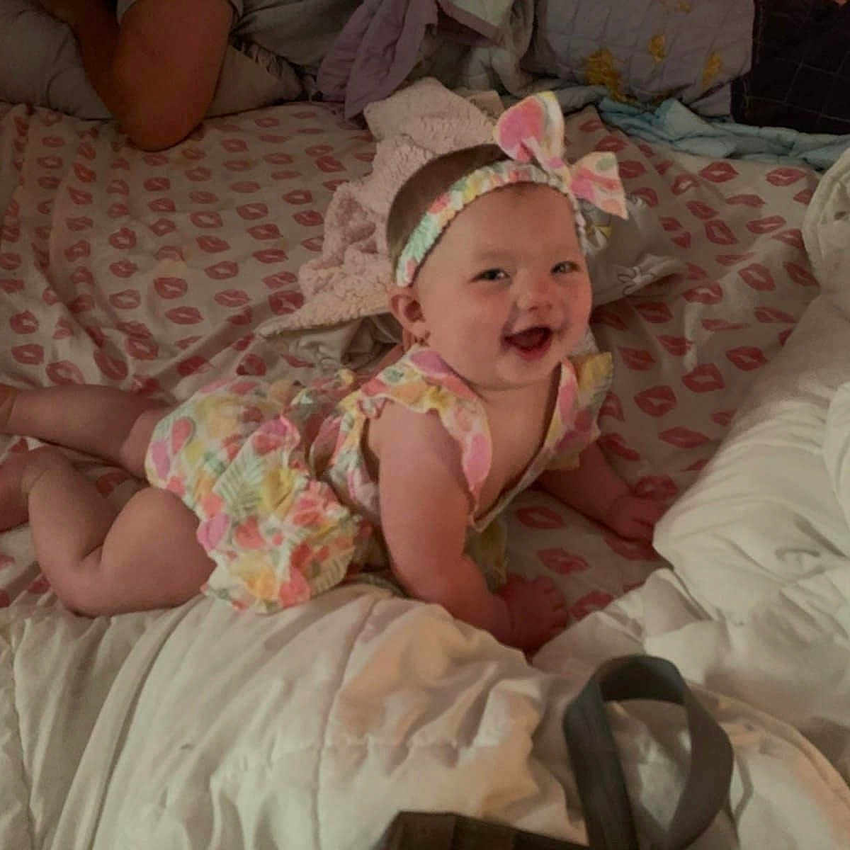 Legendary joined the competition — help win amazing prizes! baby, babylaughing, bed, bedroom, clothing, cushion, dress, face, furniture, happy, hat, head, homedecor, indoors, newborn, person, photography, portrait, quilt, room