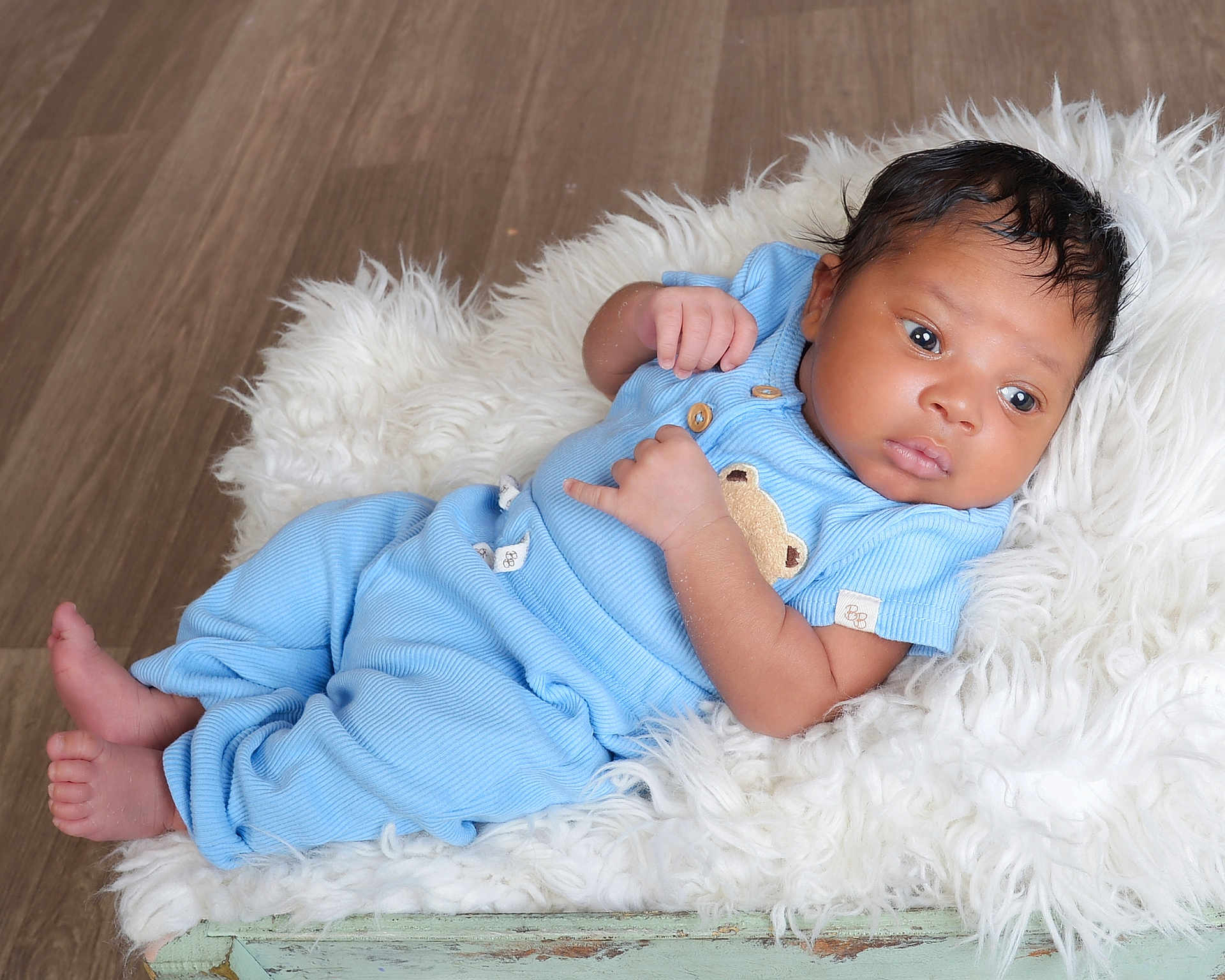 Sadio joined the competition — help win amazing prizes! baby, blanket, blue_clothing, child, cozy, cute, face, foot, fur_blanket, hand, indoors, infant, newborn, pajamas, portrait, resting, skin, sleepwear, soft, wooden_floor