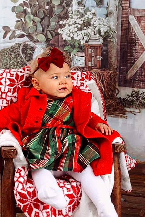 Ayviyannah is registered to the contest to win money with this photo: baby, baby_toddler_clothing, bonnet, child, child_model, christmas, costume_accessory, headwear, holiday, lap, nose, pattern, person, plaid, sock, tartan, textile, winter