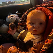 Miah is registered to the contest to win money with this photo: baby, car_seat, child, toy, stuffed_animal, seatbelt, window, night, light, indoor, car_interior, clothing, infant, cute, portrait, sitting, face, hand, travel, safety