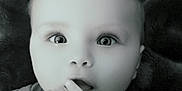Miah joined the competition — help win amazing prizes! baby, infant, face, hand, eyes, curious, monochrome, black_and_white, close_up, soft_texture, blanket, portrait, expression, young_child, cute, innocent, clothing, skin, person, newborn