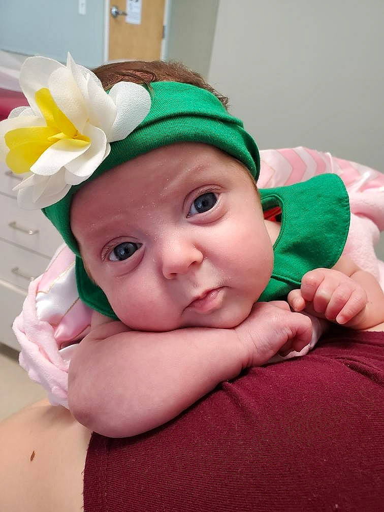 Marlow is registered to the contest to win money with this photo: baby, cheek, child, green, hand, headgear, headwear, person, skin, toddler