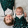 baby, blanket, bodypart, bonnet, clothing, couch, dress, face, finger, furniture, hand, happy, hat, head, newborn, people, person, photography, portrait, smile