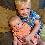 Kolton Knight joined the competition — help win amazing prizes! baby, boy, child, couch, smile, indoor, portrait, sitting, clothing, holding, person, infant, cute, family, happy, skin, face, furniture, blue_eyes, plaid_shirt