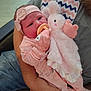 arm, baby, bunny, child, comfort, cute, hand, headband, holding, indoor, infant, mittens, newborn, pacifier, person, pink_clothing, plush_toy, resting, seated, soft_texture