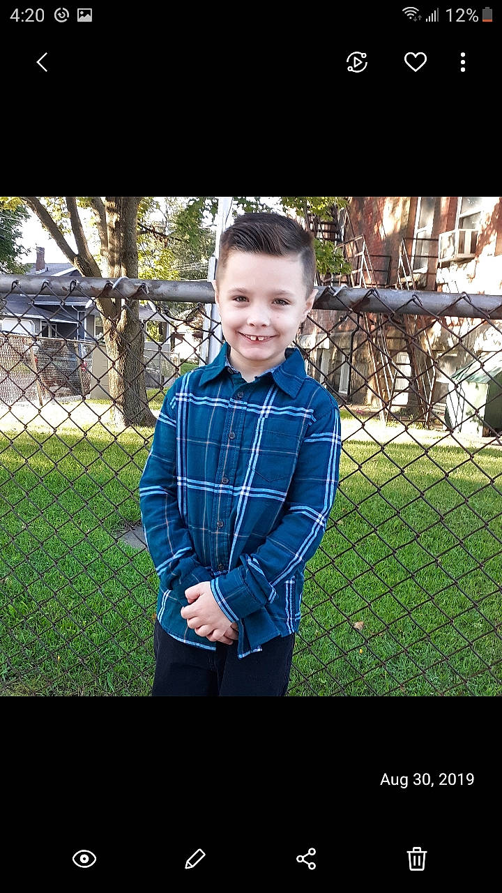 Brenden is registered to the contest to win money with this photo: child, cool, design, eye, grass, green, head, joy, lawn, outerwear, pattern, people, person, photograph, photography, plaid, smile, snapshot, standing, tartan