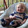baby, child, smiling, socks, pants, shirt, baby_chair, outdoor, grass, porch, railing, happy, person, face, young_child, casual_clothing, seat, feet, cute, infant