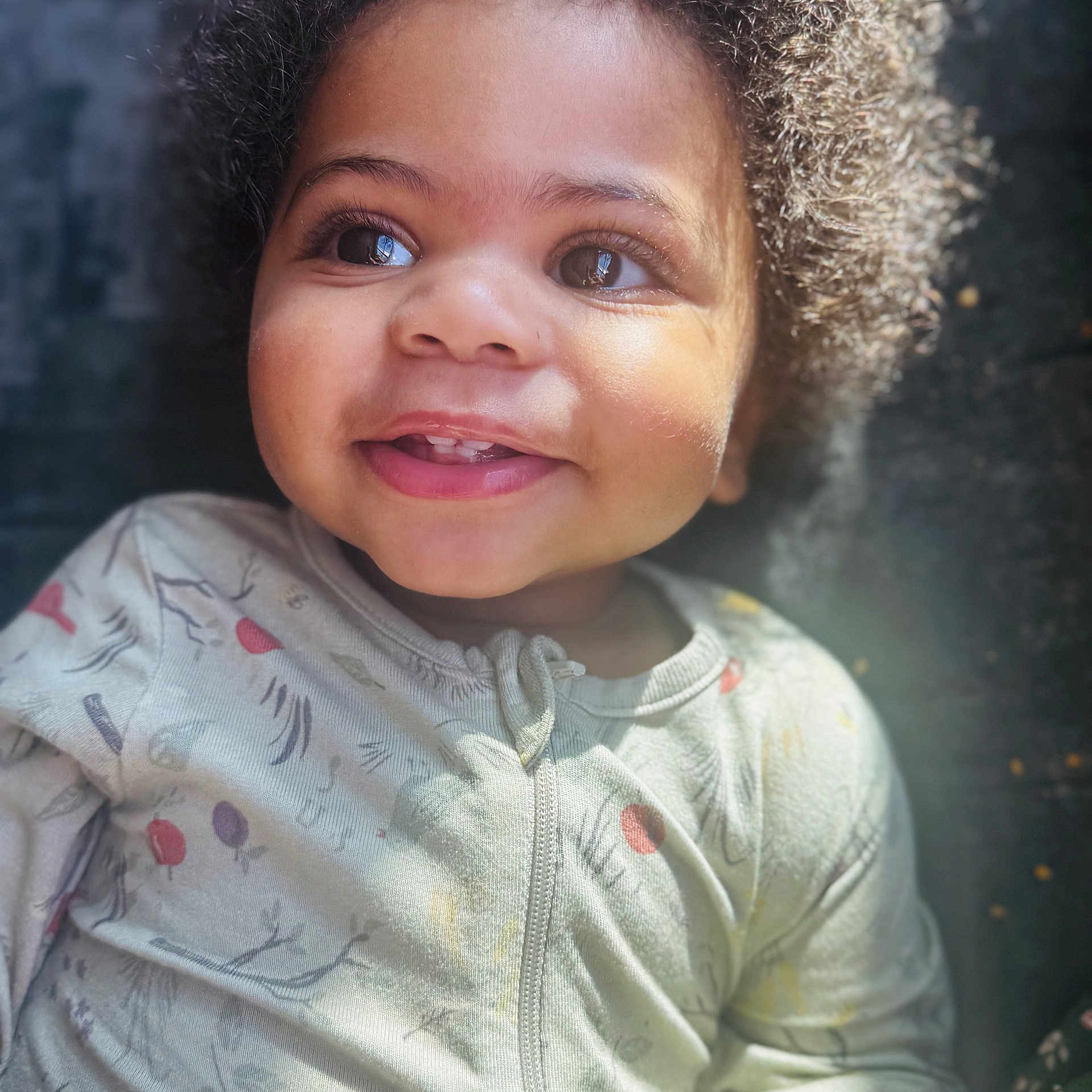 Zyun Sanders is registered to the contest to win money with this photo: toddler, child, smiling, curly_hair, onesie, face, portrait, baby, happy, cute, indoors, soft_light, skin, eyes, mouth, expression, infant, cozy, closeup, person