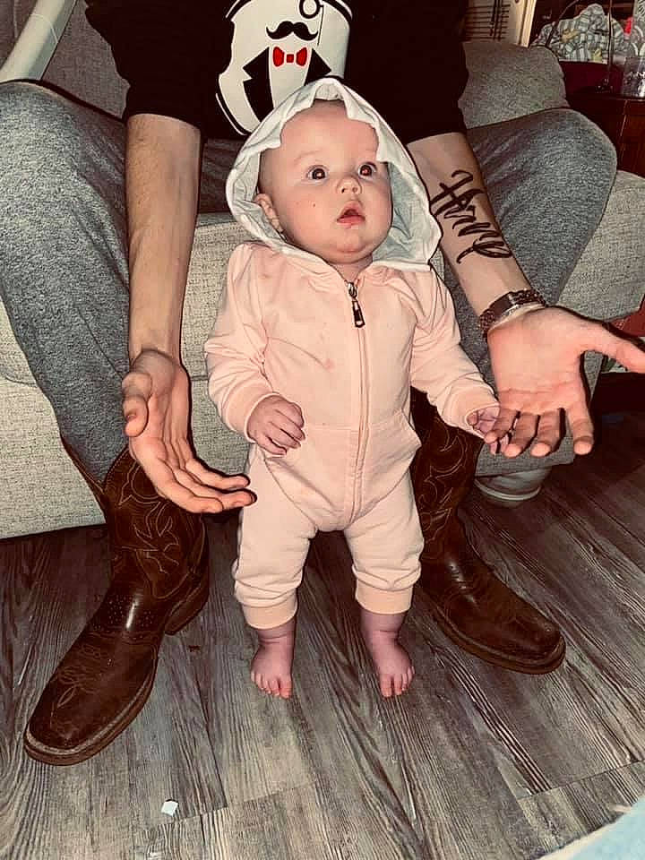 Honor is registered to the contest to win money with this photo: baby, baby_toddler_clothing, child, cool, flooring, foot, fun, fur, hand, happy, hardwood, hat, headwear, human_leg, lap, leg, mammal, person, sitting, thigh