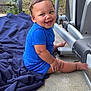 toddler, child, blue_clothing, blanket, outdoor, smiling, exercise_equipment, concrete_floor, grass, happy, baby, person, sitting, playful, cute, young_child, footwear, short_sleeves, head, face