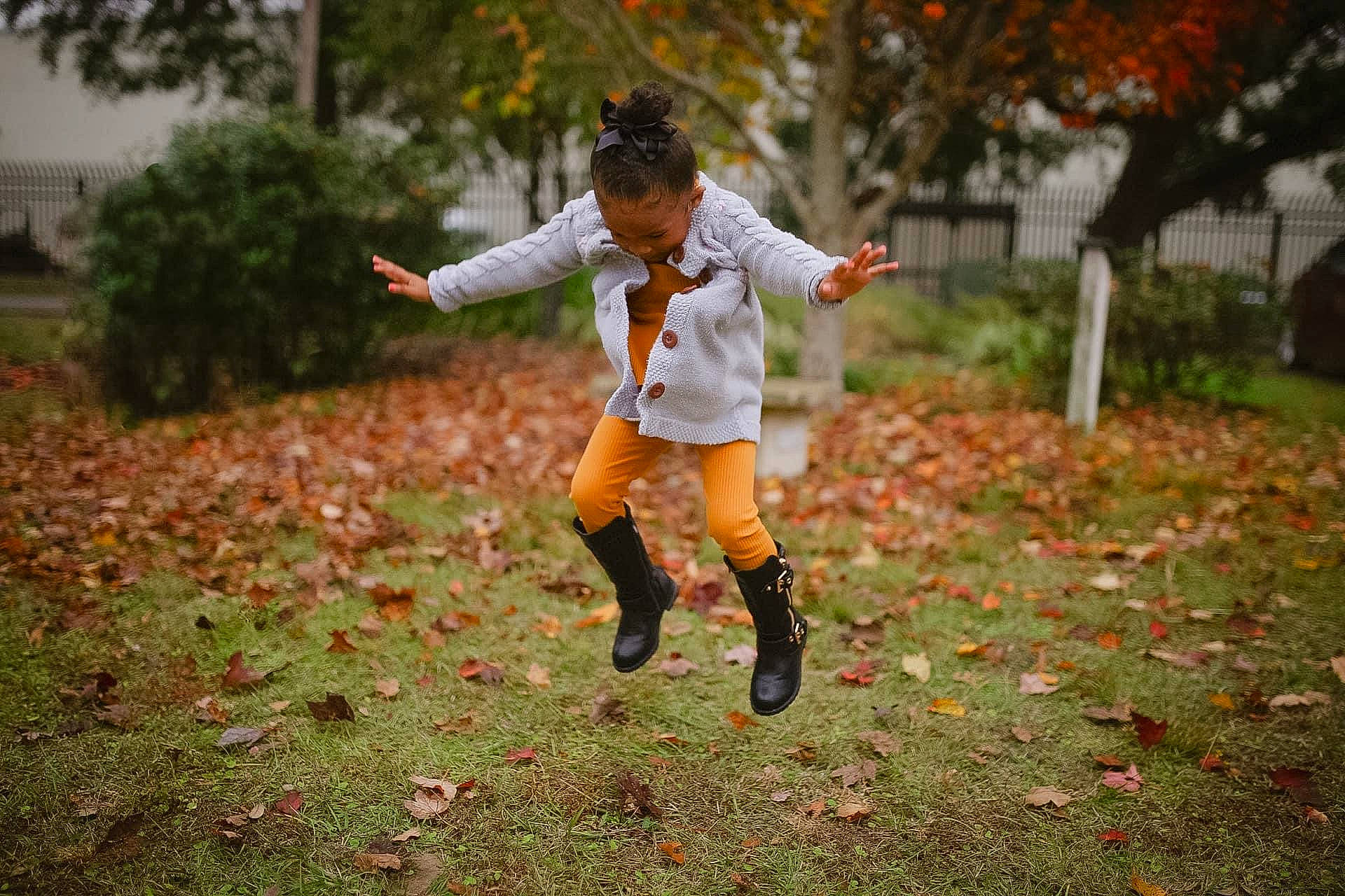 Asia is registered to the contest to win money with this photo: boot, deciduous, flash_photography, football, footwear, gesture, grass, grassland, happy, lawn, leg, leisure, people_in_nature, person, plant, recreation, shoe, shorts, sneakers, toddler