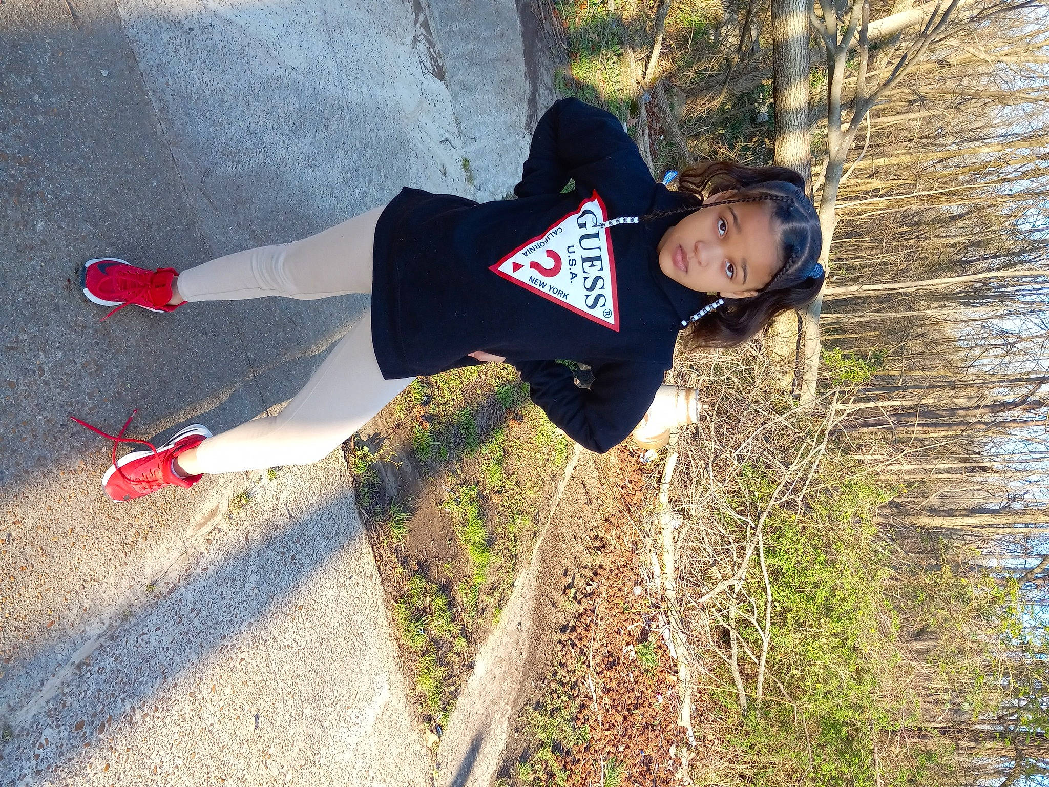 Olivia is registered to the contest to win money with this photo: active_pants, adventure, fun, grass, happy, landscape, leisure, people_in_nature, person, plant, recreation, shadow, smile, soil, sportswear, sweatpant, tree, trunk, walking, winter