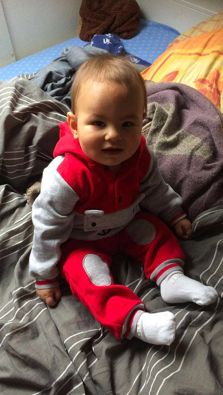 Taho participe au concours pour gagner de l'argent avec cette photo : baby, baby_carriage, baby_products, baby_toddler_clothing, carmine, cheek, child, comfort, flooring, fun, fur, grass, happy, lap, linens, person, sitting, skin, smile, toddler