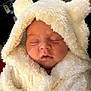 Evie is registered to the contest to win money with this photo: baby, sleeping, hoodie, fluffy, white, cute, infant, face, closed_eyes, soft, warm, cozy, child, portrait, apparel, young_child, adorable, resting, cuteness, fur_texture