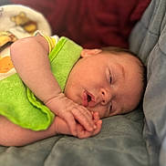 Evie is registered to the contest to win money with this photo: baby, sleeping, infant, child, green_cloth, blanket, closeup, soft, cozy, peaceful, face, hand, skin, lying_down, indoors, portrait, newborn, cute, resting, toddler