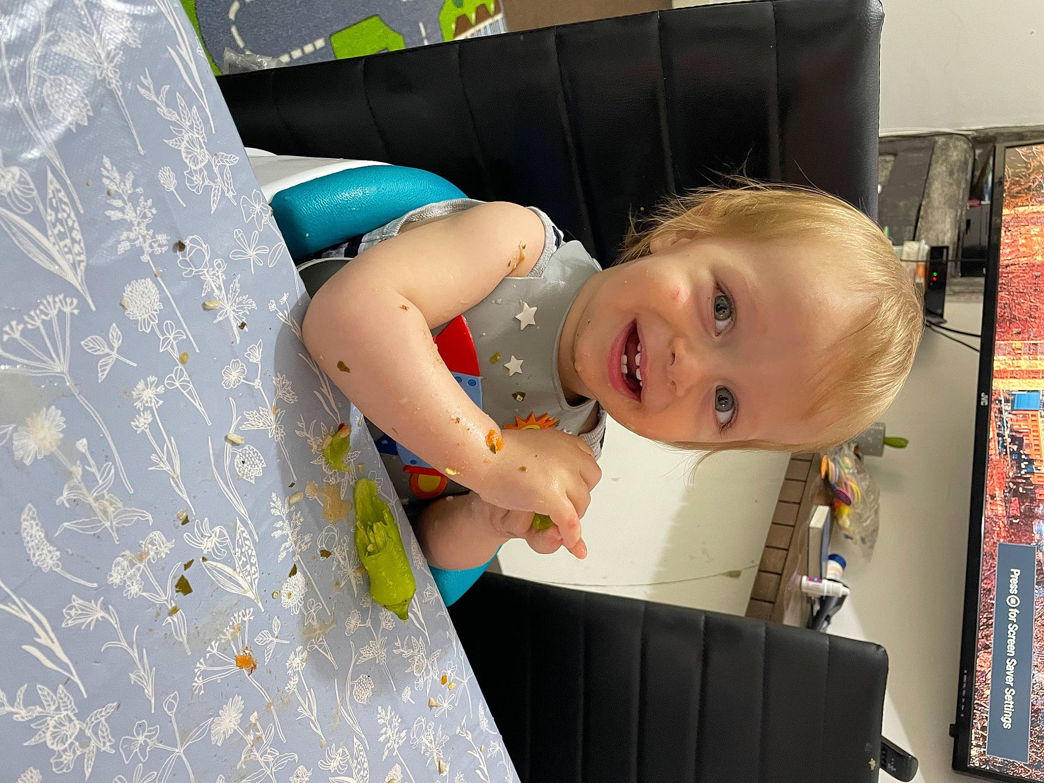 Theodor is registered to the contest to win money with this photo: baby, baby_products, baby_toddler_clothing, child, dress, fun, happy, joy, pattern, person, play, product, room, sitting, smile, t_shirt, toddler