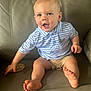 baby, child, polo_shirt, shorts, sitting, couch, leather, foot, hand, face, happy, smiling, blue, striped, skin, indoors, person, young_child, expression, casual_clothing