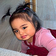 Emillia is registered to the contest to win money with this photo: child, toddler, baby, indoor, hardwood_floor, wooden_table, sofa, pink_clothing, red_dress, hair_ties, pigtails, cute, crawling, floor, big_eyes, chubby_cheeks, close_up, living_room, furniture, sofa_texture